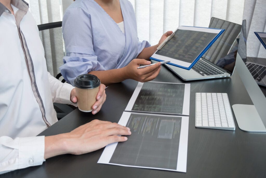 Team of programmers working with computer programming, professional development, and coding technology for an artificial intelligence project.