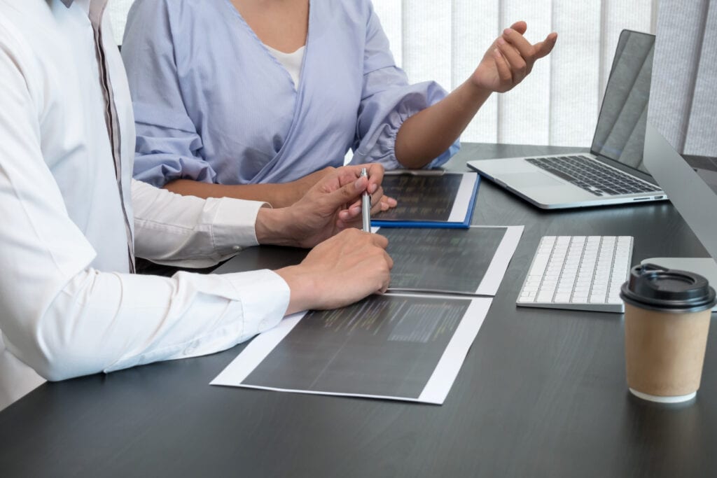 Team of programmers working with computer programming, professional development, and coding technology for an artificial intelligence project.